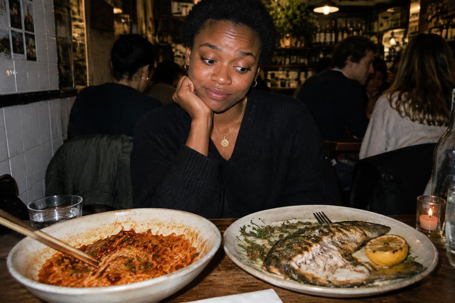 A diner weighs up spicy noodles and grilled fish at a busy neighbourhood restaurant.